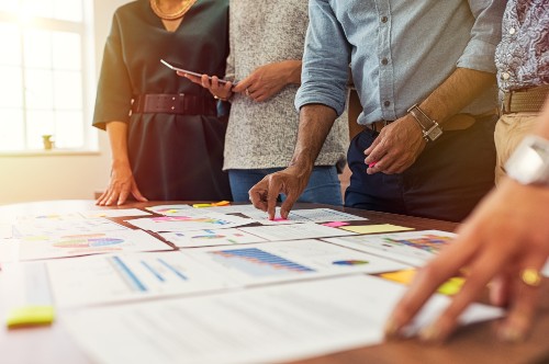 people in a meeting looking at printed documents
